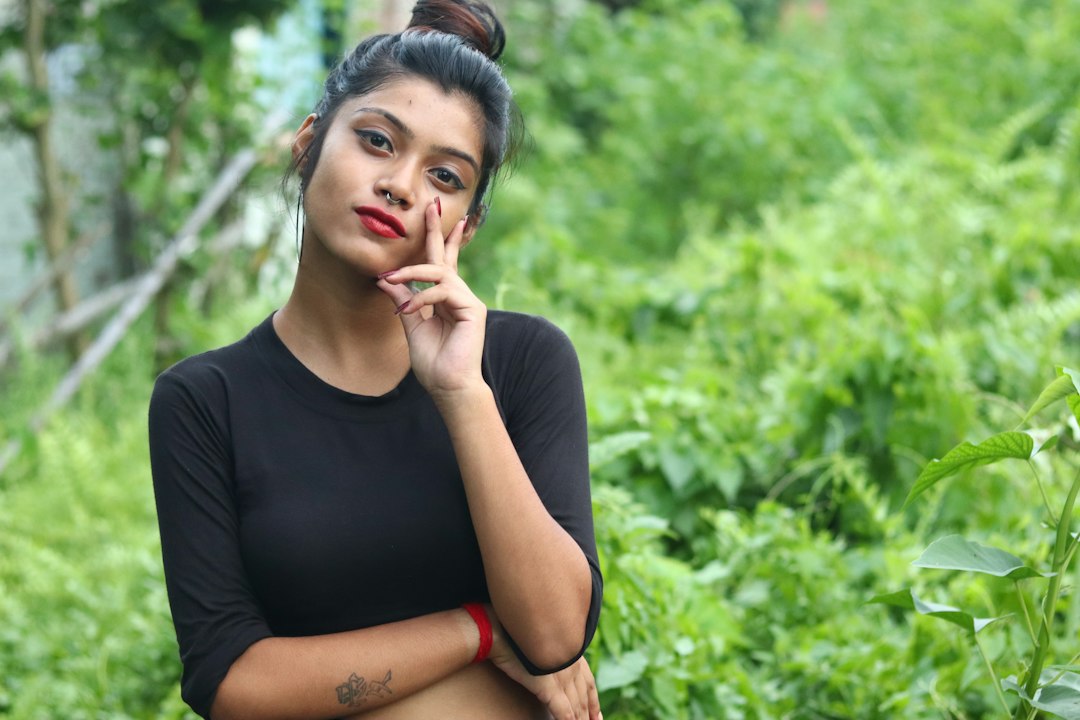 Young Indian woman with clear, balanced skin posing outdoors in modern styling