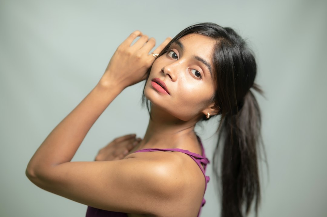 Young Indian woman with glowing, healthy skin in a modern studio portrait, representing daily sun protection for Indian skin